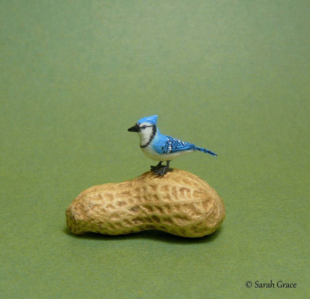 Detailed 1:12 scale blue jay bird figurine by Sarah Grace, featuring realistic blue feathers and perched pose
