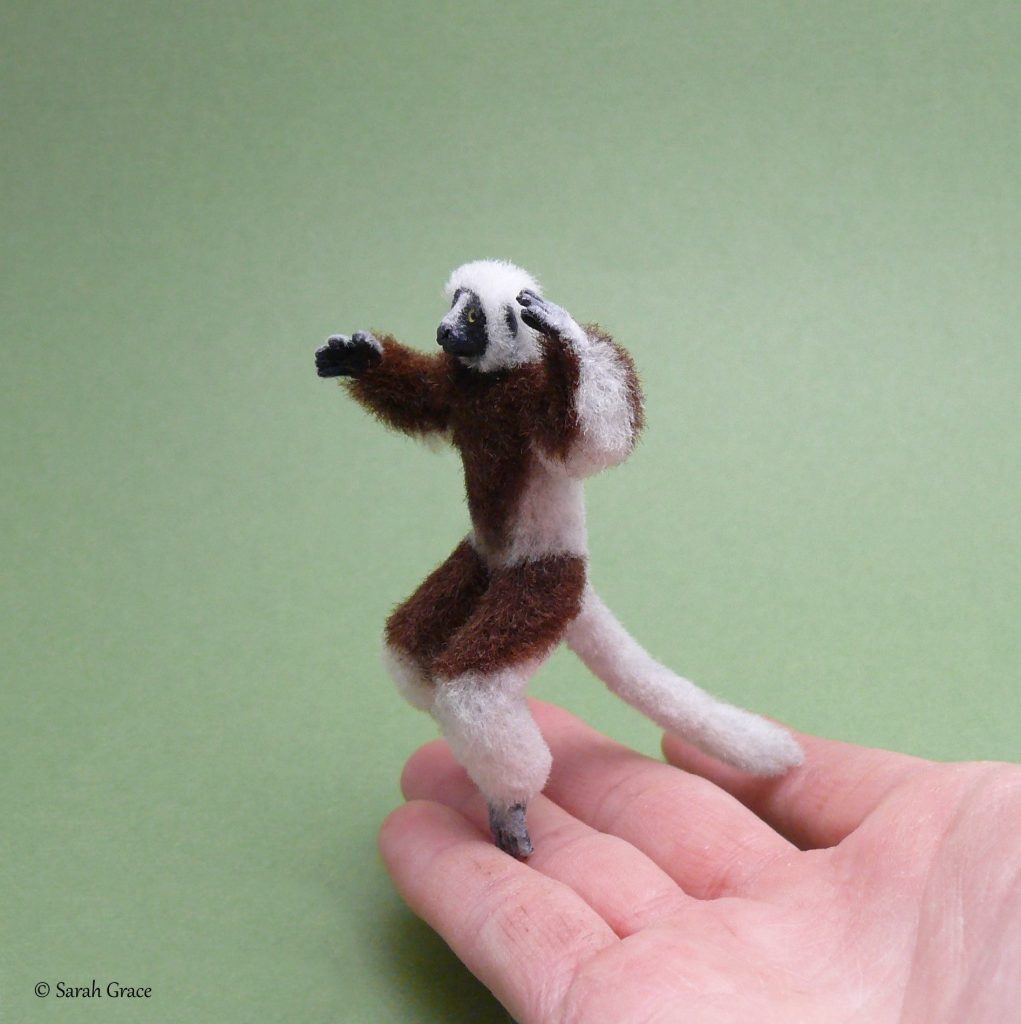 Playful handmade miniature ring-tailed lemur sculpture by Sarah Grace